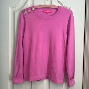 Lilly Pulitzer pink sweater with gold and diamond buttons.
